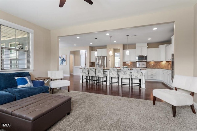 2333 Lantern Walk Ln, Wake Forest, NC 27587 - living area with plenty of natural light, ceiling fan, recessed lighting, dark colored carpet, and baseboards