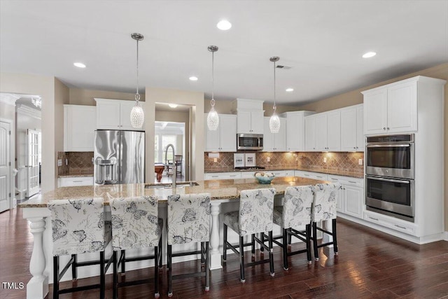 2333 Lantern Walk Ln, Wake Forest, NC 27587 - kitchen featuring appliances with stainless steel finishes, a sink, a spacious island, backsplash, and recessed lighting