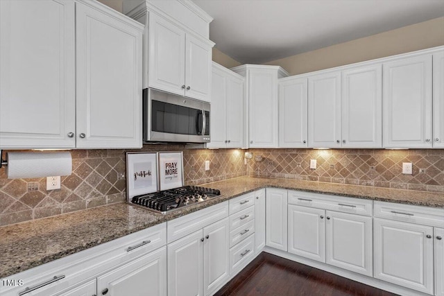 2333 Lantern Walk Ln, Wake Forest, NC 27587 - kitchen featuring appliances with stainless steel finishes, white cabinetry, dark wood finished floors, stone countertops, and tasteful backsplash