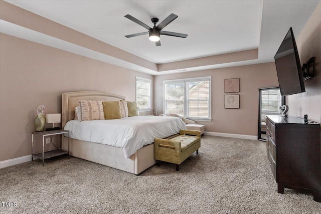 2333 Lantern Walk Ln, Wake Forest, NC 27587 - bedroom with a tray ceiling, light colored carpet, multiple windows, and baseboards
