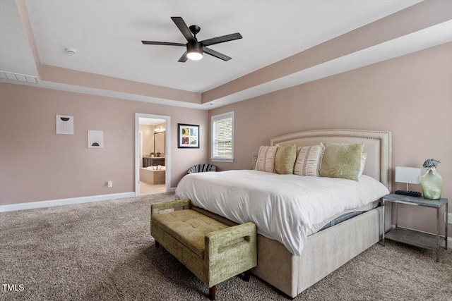 2333 Lantern Walk Ln, Wake Forest, NC 27587 - carpeted bedroom with baseboards, a ceiling fan, connected bathroom, and a tray ceiling