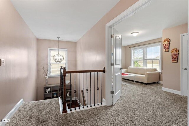 2333 Lantern Walk Ln, Wake Forest, NC 27587 - hallway featuring carpet flooring, baseboards, a chandelier, and an upstairs landing