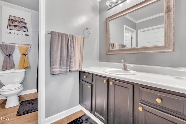 144 Shawnee Dr, Louisburg, NC 27549 - bathroom featuring crown molding, vanity, toilet, wood finished floors, and baseboards