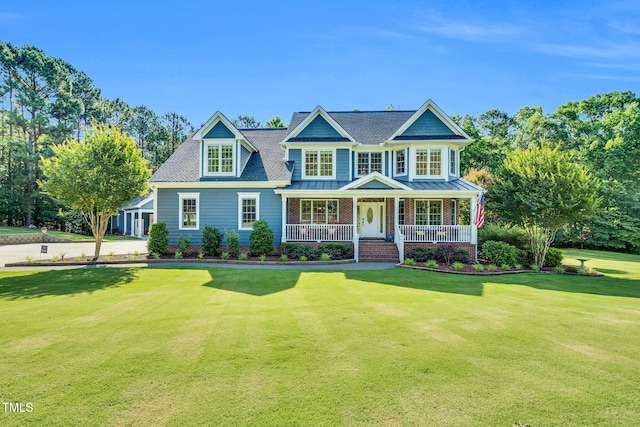 227 Paraggi Ct, Clayton, NC 27527 - view of front of home featuring a porch, a front lawn, a standing seam roof, and metal roof