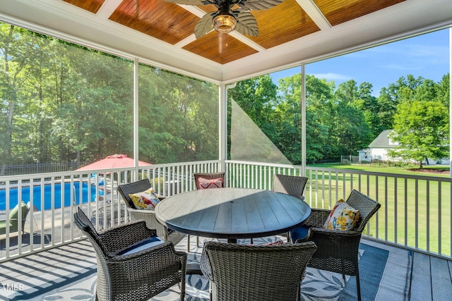 227 Paraggi Ct, Clayton, NC 27527 - wooden deck with a ceiling fan, outdoor dining space, and view of scattered trees