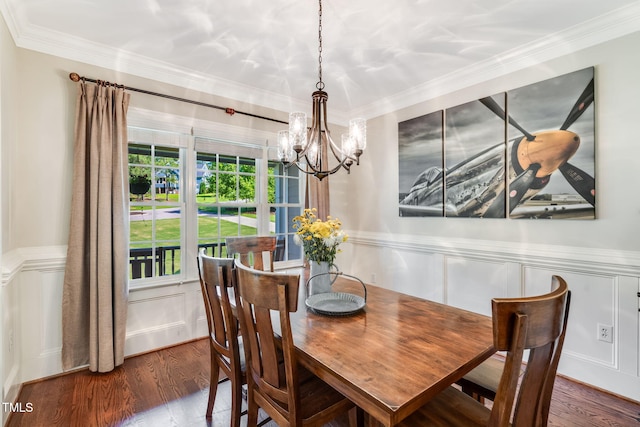 227 Paraggi Ct, Clayton, NC 27527 - dining room featuring a chandelier, a decorative wall, wood finished floors, crown molding, and wainscoting
