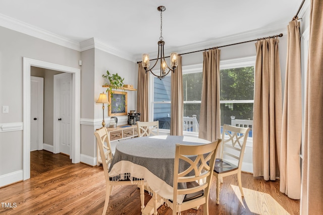 227 Paraggi Ct, Clayton, NC 27527 - dining space featuring a chandelier, crown molding, light wood-style floors, and baseboards