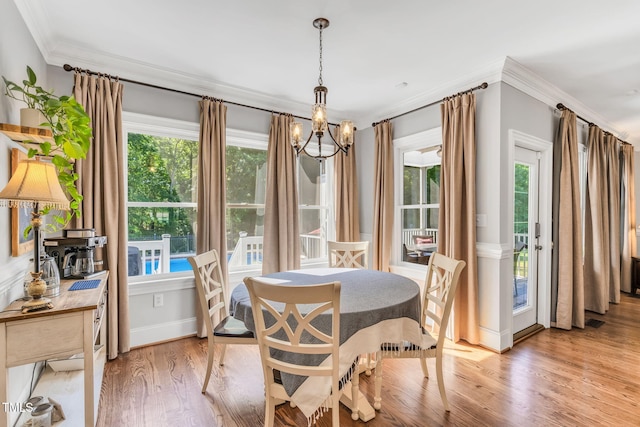 227 Paraggi Ct, Clayton, NC 27527 - dining area with light wood-style floors, a chandelier, ornamental molding, and baseboards