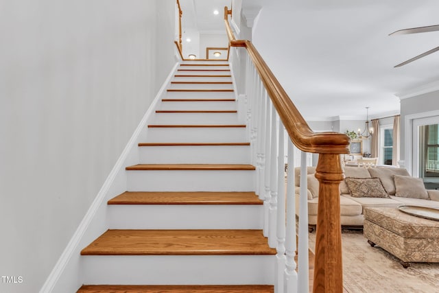 227 Paraggi Ct, Clayton, NC 27527 - stairs with ornamental molding, a chandelier, and wood finished floors