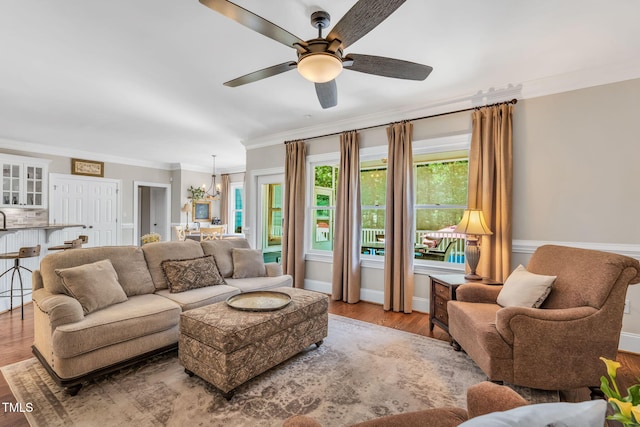 227 Paraggi Ct, Clayton, NC 27527 - living area featuring a ceiling fan, a chandelier, ornamental molding, and wood finished floors