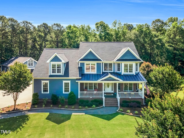 227 Paraggi Ct, Clayton, NC 27527 - view of front of property featuring a front yard, a porch, a standing seam roof, and a shingled roof
