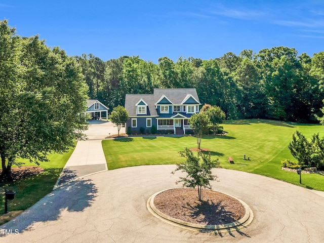 227 Paraggi Ct, Clayton, NC 27527 - view of front facade with curved driveway, a front yard, and a porch