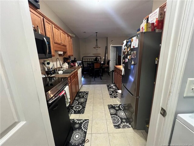 621 Marshtree Ln Unit 303, Fayetteville, NC 28314 - kitchen with appliances with stainless steel finishes, a sink, brown cabinetry, light tile patterned floors, and pendant lighting
