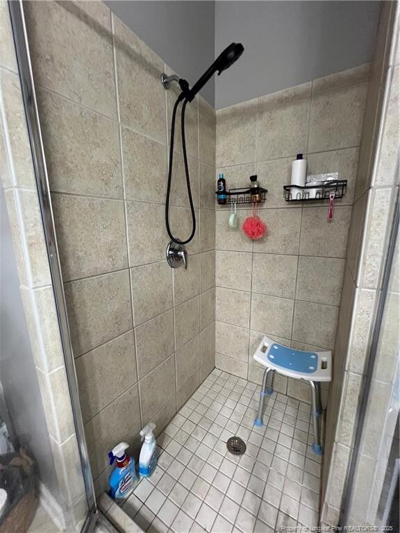 621 Marshtree Ln Unit 303, Fayetteville, NC 28314 - bathroom with a shower stall and tile patterned flooring