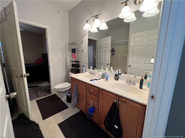 621 Marshtree Ln Unit 303, Fayetteville, NC 28314 - ensuite bathroom featuring a chandelier, double vanity, an enclosed shower, toilet, and tile patterned flooring