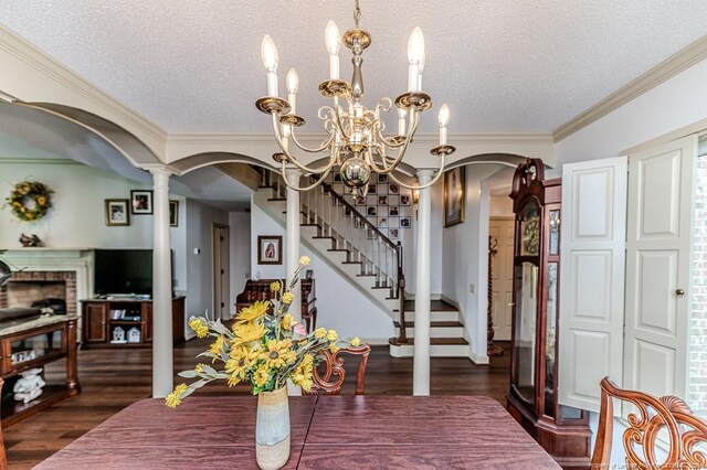 259 Golf Dr, Sanford, NC 27332 - dining room with arched walkways, a chandelier, a textured ceiling, wood finished floors, and decorative columns