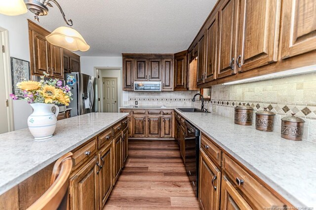 259 Golf Dr, Sanford, NC 27332 - kitchen featuring a sink, appliances with stainless steel finishes, light stone counters, dark wood-type flooring, and tasteful backsplash