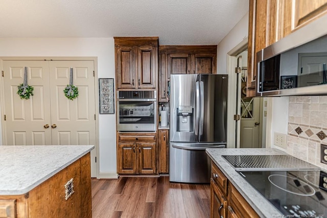 259 Golf Dr, Sanford, NC 27332 - kitchen with stainless steel appliances, dark wood-style flooring, and backsplash