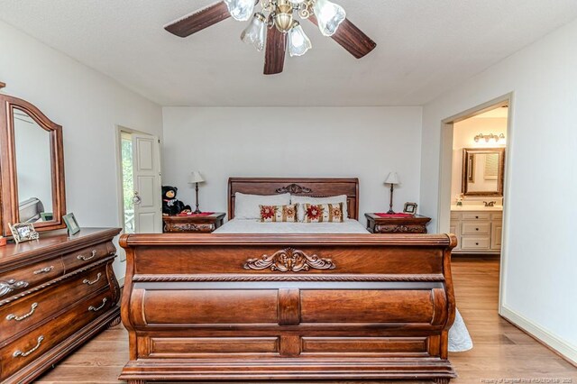 259 Golf Dr, Sanford, NC 27332 - bedroom with light wood finished floors, ensuite bathroom, and a ceiling fan