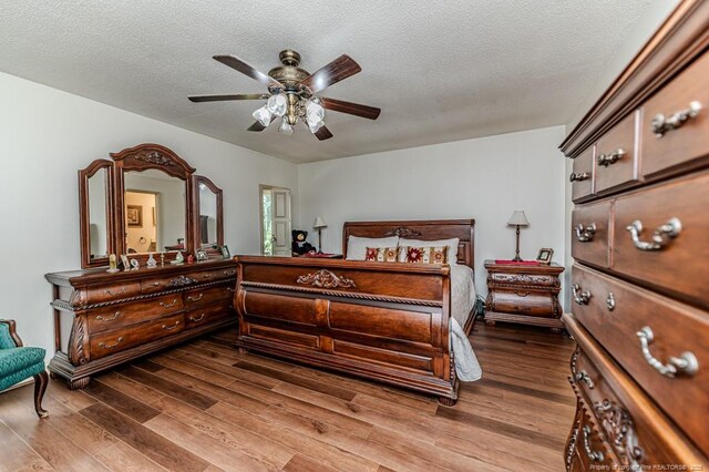259 Golf Dr, Sanford, NC 27332 - bedroom with wood finished floors, a textured ceiling, and a ceiling fan