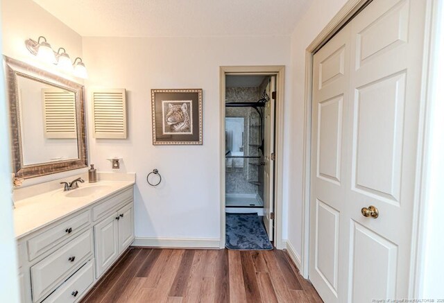 259 Golf Dr, Sanford, NC 27332 - bathroom featuring vanity, wood finished floors, and baseboards