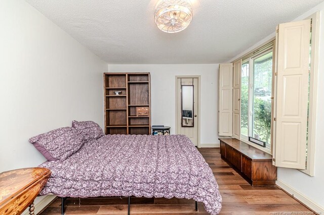 259 Golf Dr, Sanford, NC 27332 - bedroom featuring wood finished floors, a textured ceiling, and baseboards