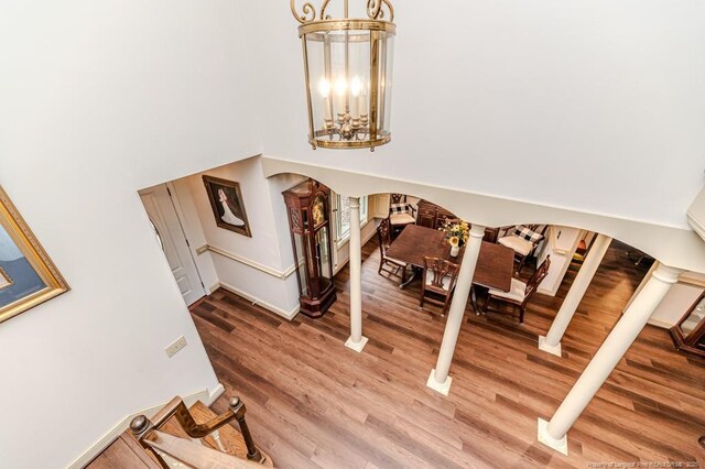 259 Golf Dr, Sanford, NC 27332 - stairs featuring arched walkways, wood finished floors, a chandelier, baseboards, and a high ceiling