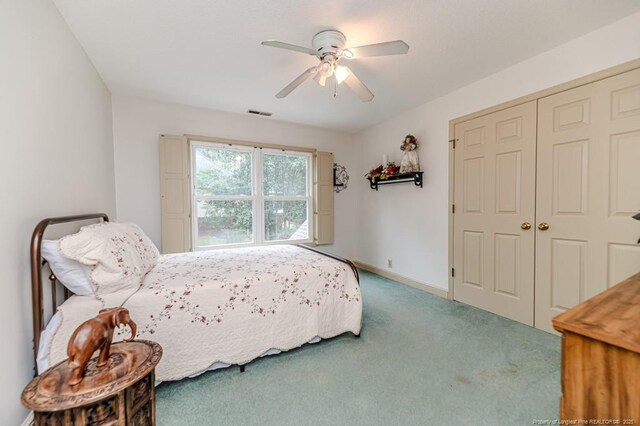 259 Golf Dr, Sanford, NC 27332 - carpeted bedroom featuring a closet, ceiling fan, and baseboards