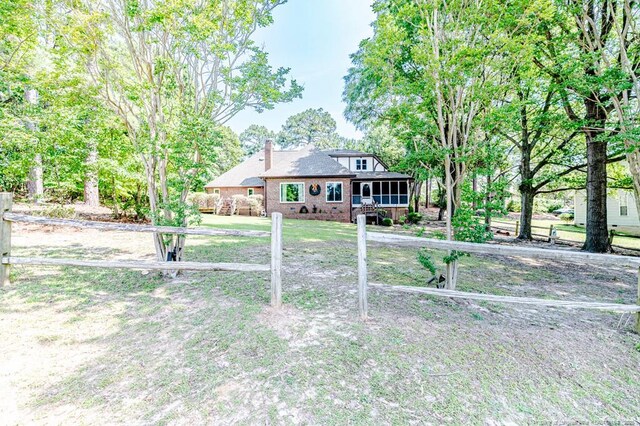 259 Golf Dr, Sanford, NC 27332 - view of front of property with brick siding, a chimney, and a sunroom