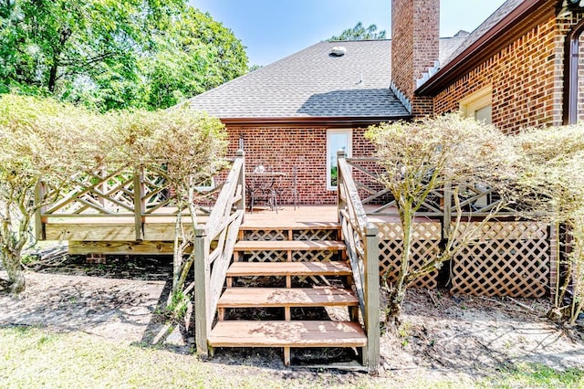 259 Golf Dr, Sanford, NC 27332 - back of house featuring brick siding, a chimney, roof with shingles, and a deck