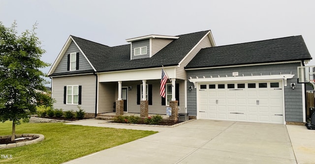 137 Clydes Point Way, Wendell, NC 27591 - view of front of property with a porch, driveway, a front lawn, an attached garage, and roof with shingles