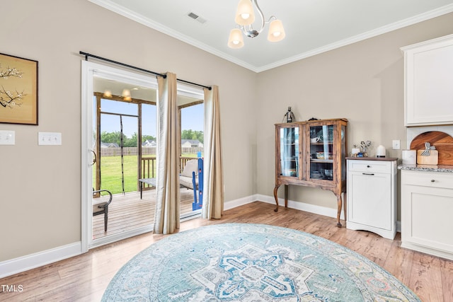 137 Clydes Point Way, Wendell, NC 27591 - dining area featuring crown molding, a chandelier, light wood-style flooring, and baseboards