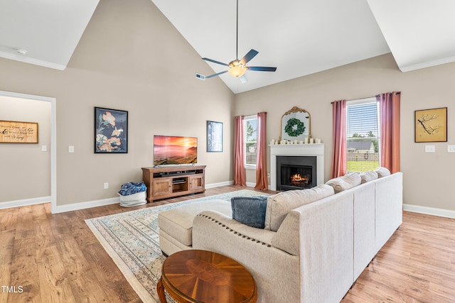 137 Clydes Point Way, Wendell, NC 27591 - living area featuring ceiling fan, light wood-type flooring, healthy amount of natural light, a warm lit fireplace, and high vaulted ceiling