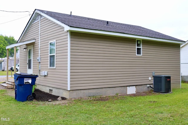 102 E Nash St, Elm City, NC 27822 - view of home's exterior featuring central air condition unit, crawl space, a lawn, and roof with shingles