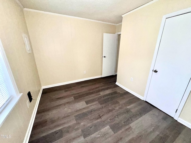 102 E Nash St, Elm City, NC 27822 - unfurnished bedroom featuring dark wood-style floors, crown molding, and baseboards