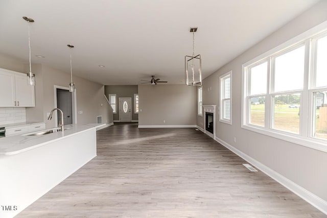 117 Knight Rd, Broadway, NC 27505 - unfurnished living room featuring a sink, a ceiling fan, a fireplace, and baseboards