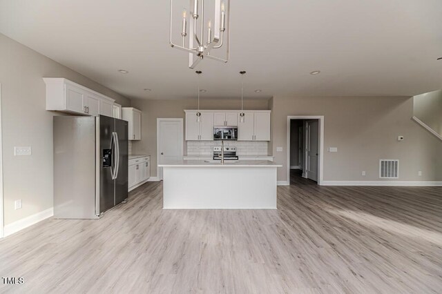 117 Knight Rd, Broadway, NC 27505 - kitchen featuring appliances with stainless steel finishes, open floor plan, light countertops, baseboards, and decorative backsplash