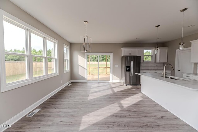 117 Knight Rd, Broadway, NC 27505 - kitchen featuring stainless steel fridge, a sink, decorative light fixtures, and baseboards