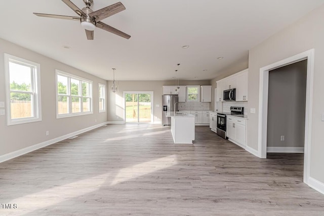 117 Knight Rd, Broadway, NC 27505 - unfurnished living room featuring baseboards, light wood-style floors, and ceiling fan