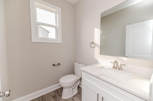 117 Knight Rd, Broadway, NC 27505 - half bathroom with toilet, vanity, wood finished floors, and baseboards