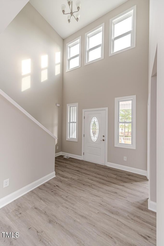 117 Knight Rd, Broadway, NC 27505 - entrance foyer with a high ceiling, a chandelier, light wood-type flooring, and baseboards