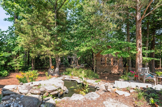 648 Long Melford Dr, Rolesville, NC 27571 - view of yard with a garden pond and an outdoor structure