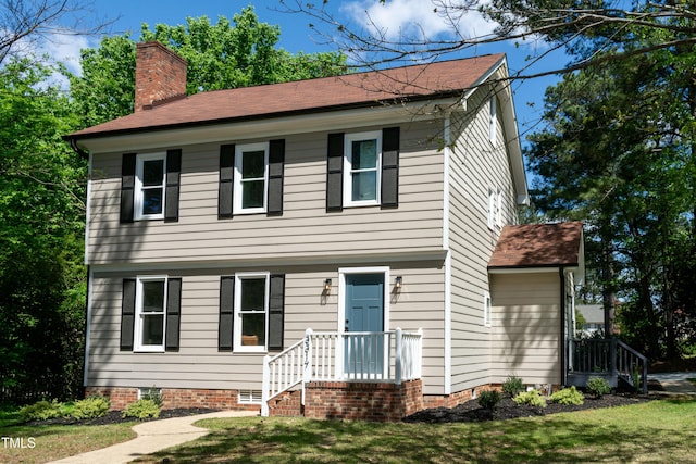 3317 E Jameson Rd, Raleigh, NC 27604 - colonial-style house with a chimney, a front yard, and a shingled roof