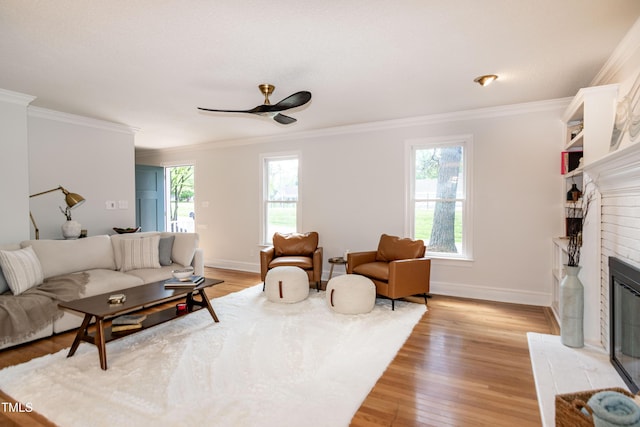 3317 E Jameson Rd, Raleigh, NC 27604 - living area with a brick fireplace, ornamental molding, light wood finished floors, and ceiling fan