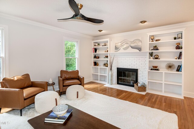 3317 E Jameson Rd, Raleigh, NC 27604 - living area featuring wood finished floors, ornamental molding, a fireplace, a ceiling fan, and built in features