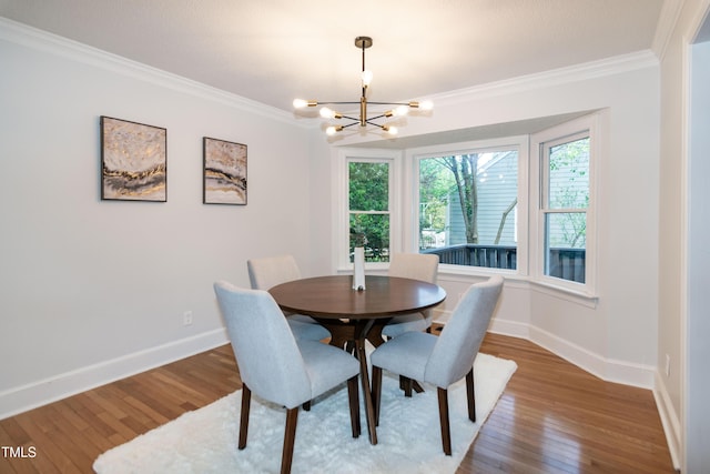 3317 E Jameson Rd, Raleigh, NC 27604 - dining space featuring crown molding, a chandelier, plenty of natural light, and wood finished floors