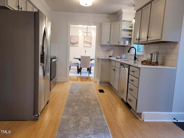 3317 E Jameson Rd, Raleigh, NC 27604 - kitchen with stainless steel appliances, light wood-style floors, open shelves, tasteful backsplash, and crown molding