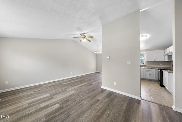 5529 Wood Pond Ct, Raleigh, NC 27610 - unfurnished living room featuring a ceiling fan, wood finished floors, a textured ceiling, baseboards, and a chandelier