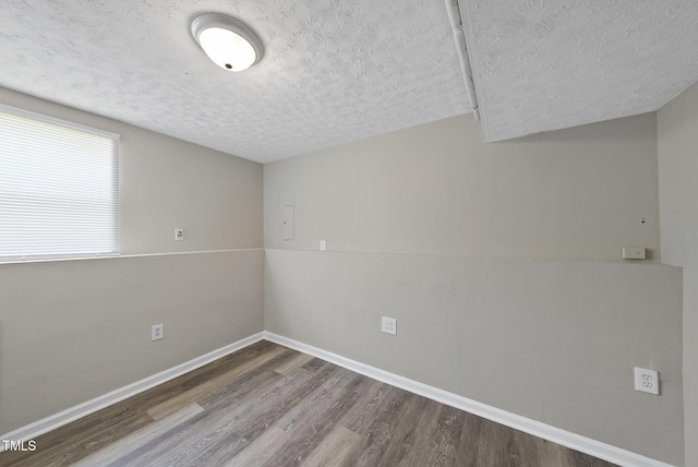 5529 Wood Pond Ct, Raleigh, NC 27610 - spare room with a textured ceiling, wood finished floors, and baseboards