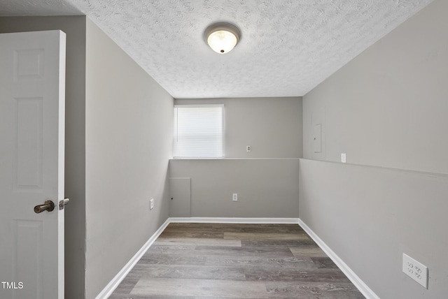 5529 Wood Pond Ct, Raleigh, NC 27610 - empty room with a textured ceiling, wood finished floors, and baseboards